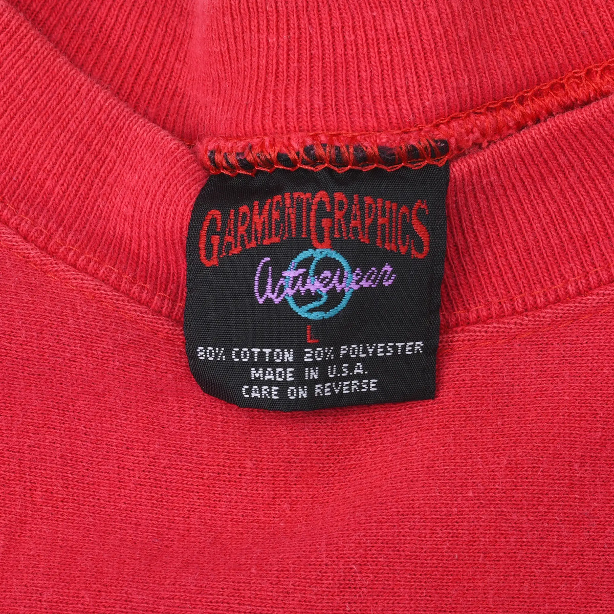 Close-up of Garment Graphics Active Wear neck label inside red sweatshirt