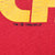 Close-up of cracked yellow print and 1994 NFLP copyright mark on red fabric