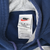 Close-up of Nike neck label marked XL inside the navy blue hoodie