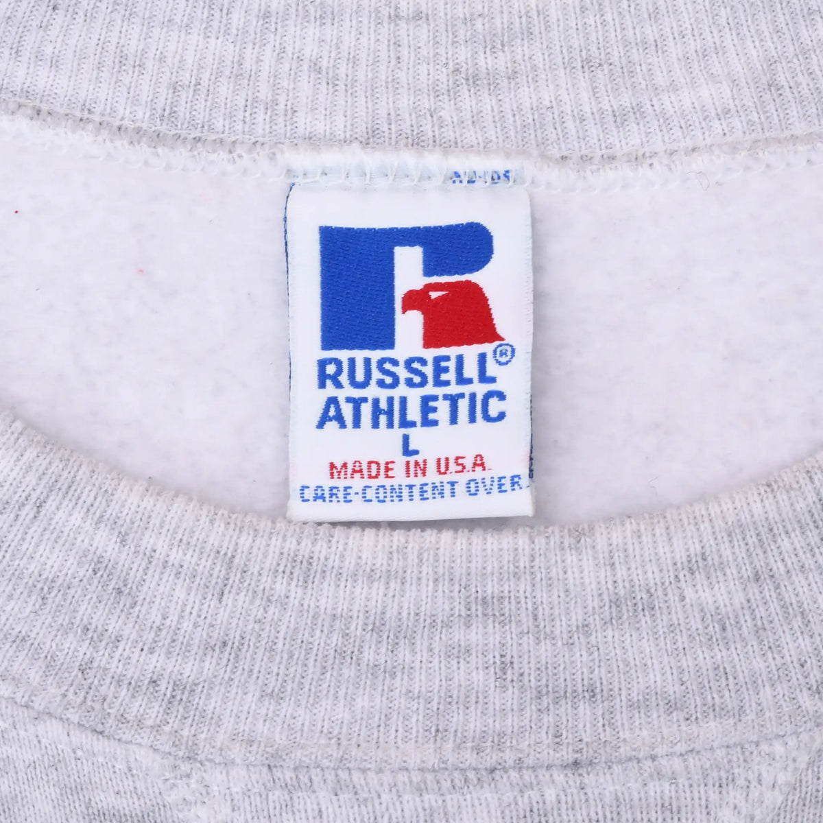 Close-up of Russell Athletic Made in USA neck label on gray sweatshirt