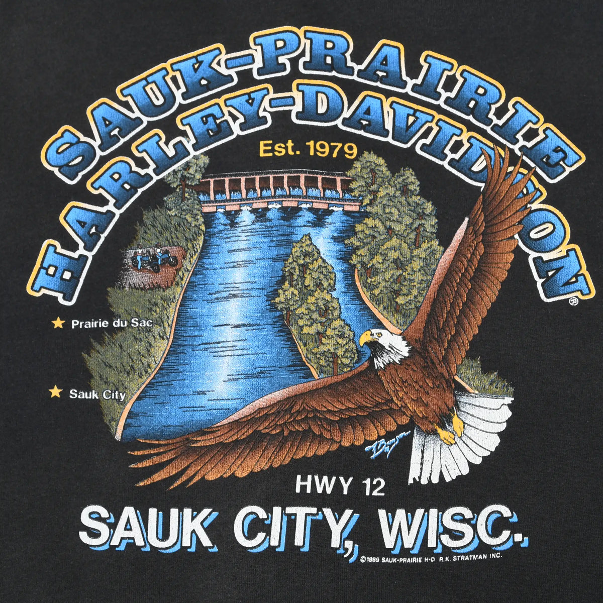 Sauk-Prairie Harley-Davidson back graphic with bald eagle, Wisconsin River, bridge, and trees