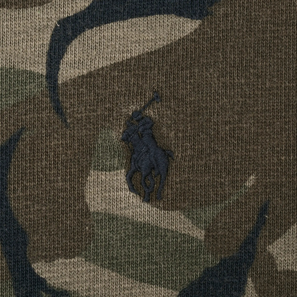 Close-up of dark Polo Ralph Lauren pony embroidery on camouflage fabric