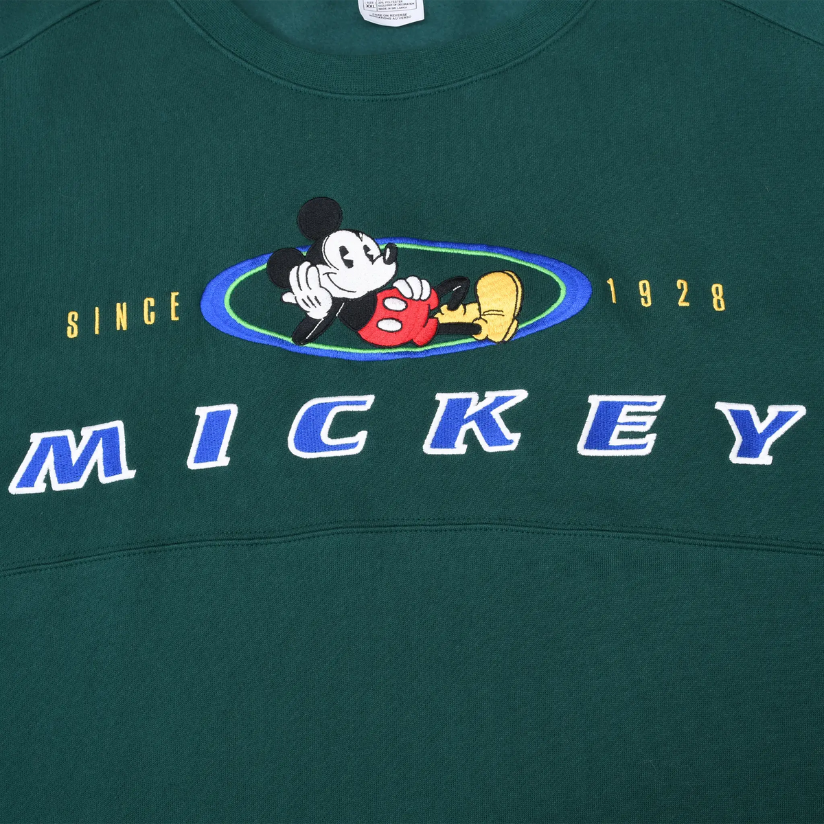 Close-up of embroidered Mickey Mouse, SINCE 1928, and MICKEY chest design