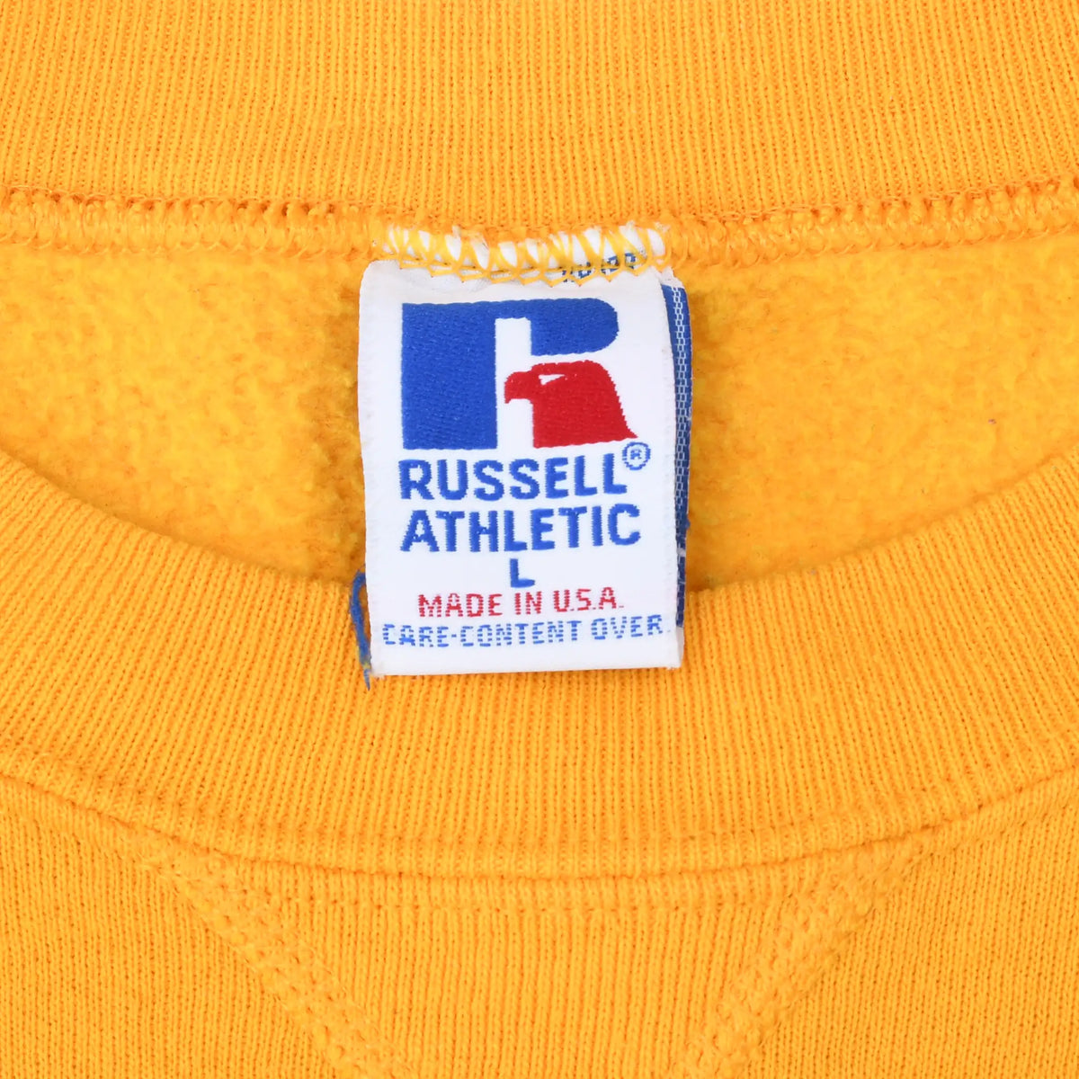 Russell Athletic size L neck label on gold sweatshirt, marked Made in USA
