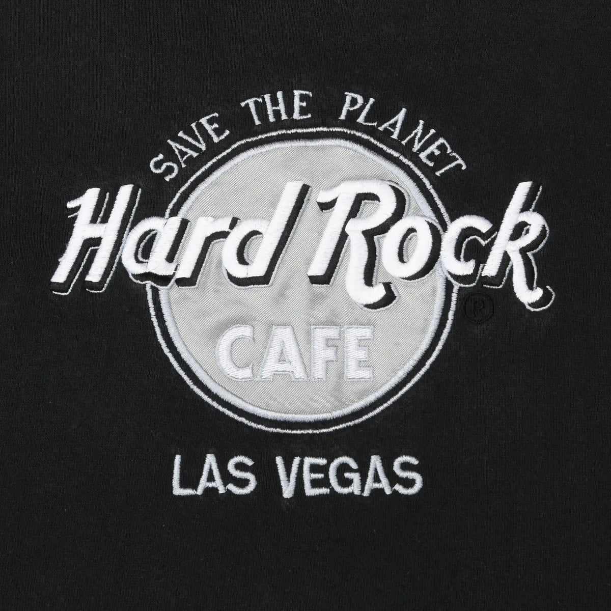 Close-up of gray and white Save the Planet Hard Rock Cafe Las Vegas chest embroidery