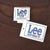 Close-up of Lee Sport neck label and attached hangtag on brown sweatshirt