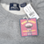 Close-up of Gap Athletics Classic neck label and attached Large retail tags