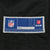 Close-up of NFL size large jock tag on black jersey