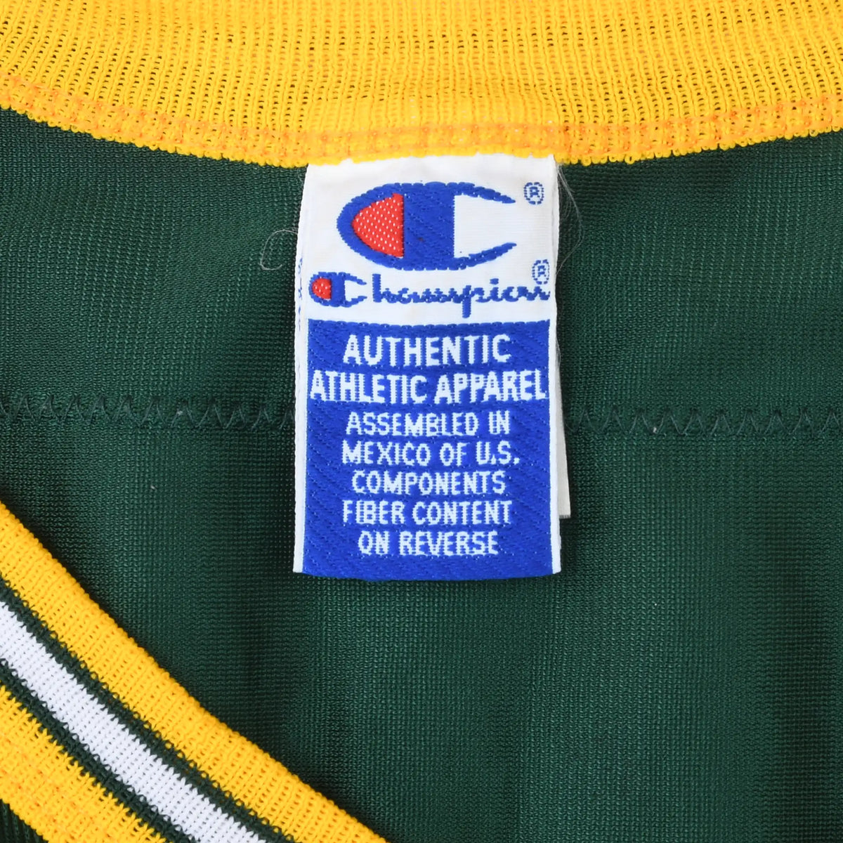 Close-up of Champion neck label inside green jersey with yellow collar