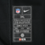 Close-up of Nike NFL Dri-FIT 3XL interior label on black jersey fabric