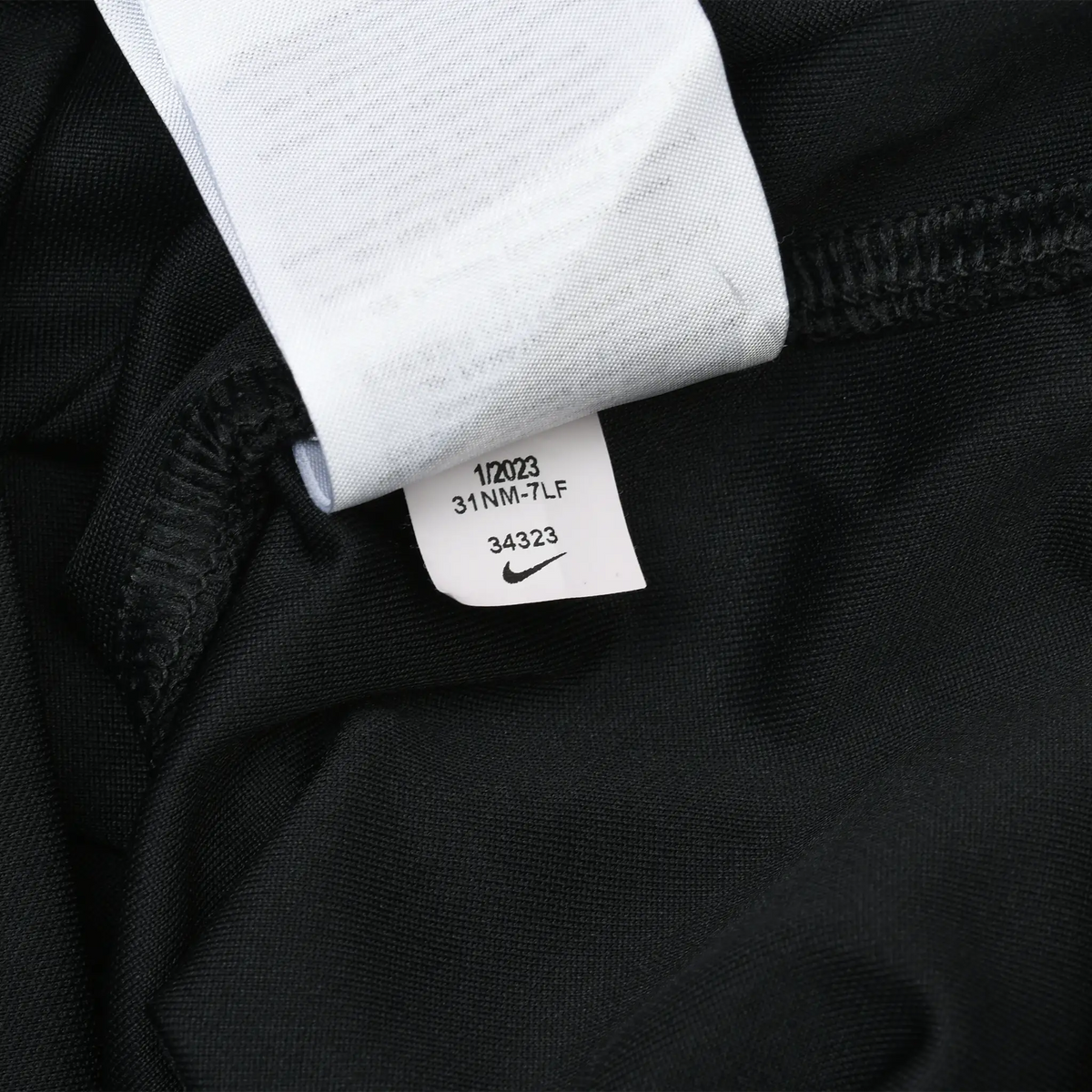 Close-up of small Nike production tag inside the black jersey