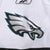 Close-up of Philadelphia Eagles logo print on white jersey sleeve
