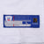 Close-up of Reebok NFL Players jersey hem label on white mesh fabric