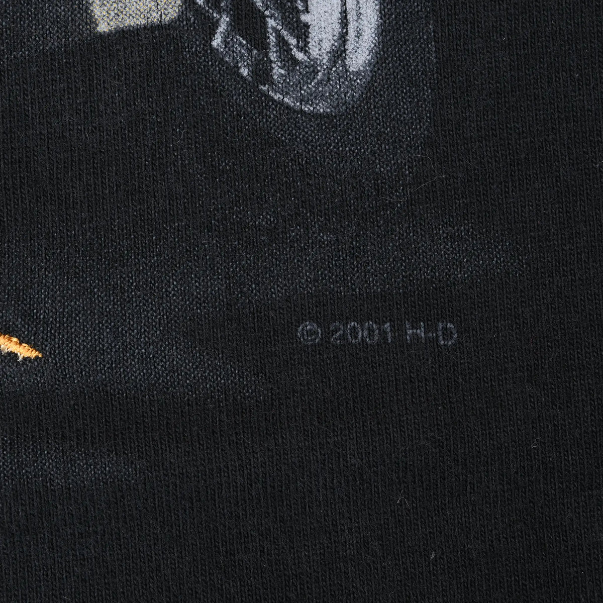 Close-up of 2001 H-D copyright mark printed on black fabric