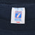 Close-up of Logo 7 neck tag marked large and Made in U.S.A. on navy fabric
