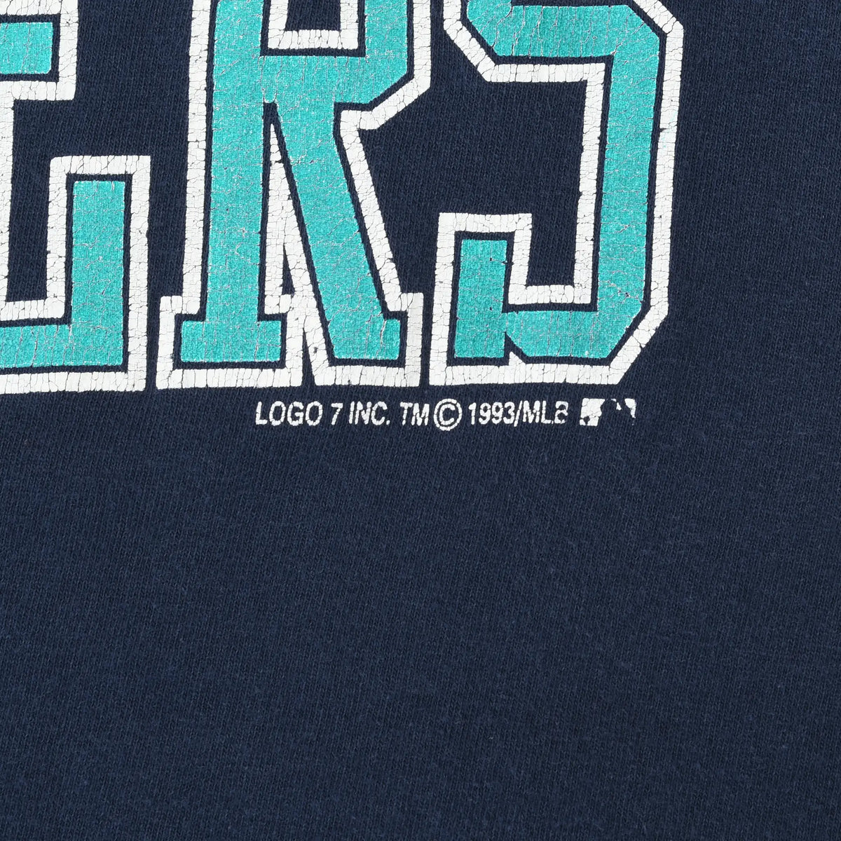 Close-up of 1993 MLB copyright text beneath the Mariners front print