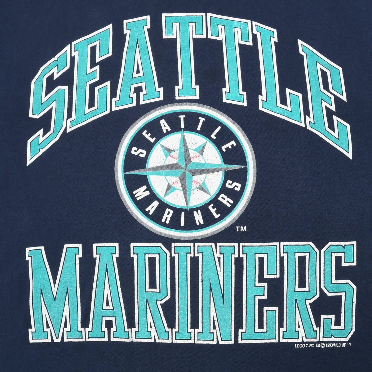 Close-up of teal and white Seattle Mariners lettering and compass logo