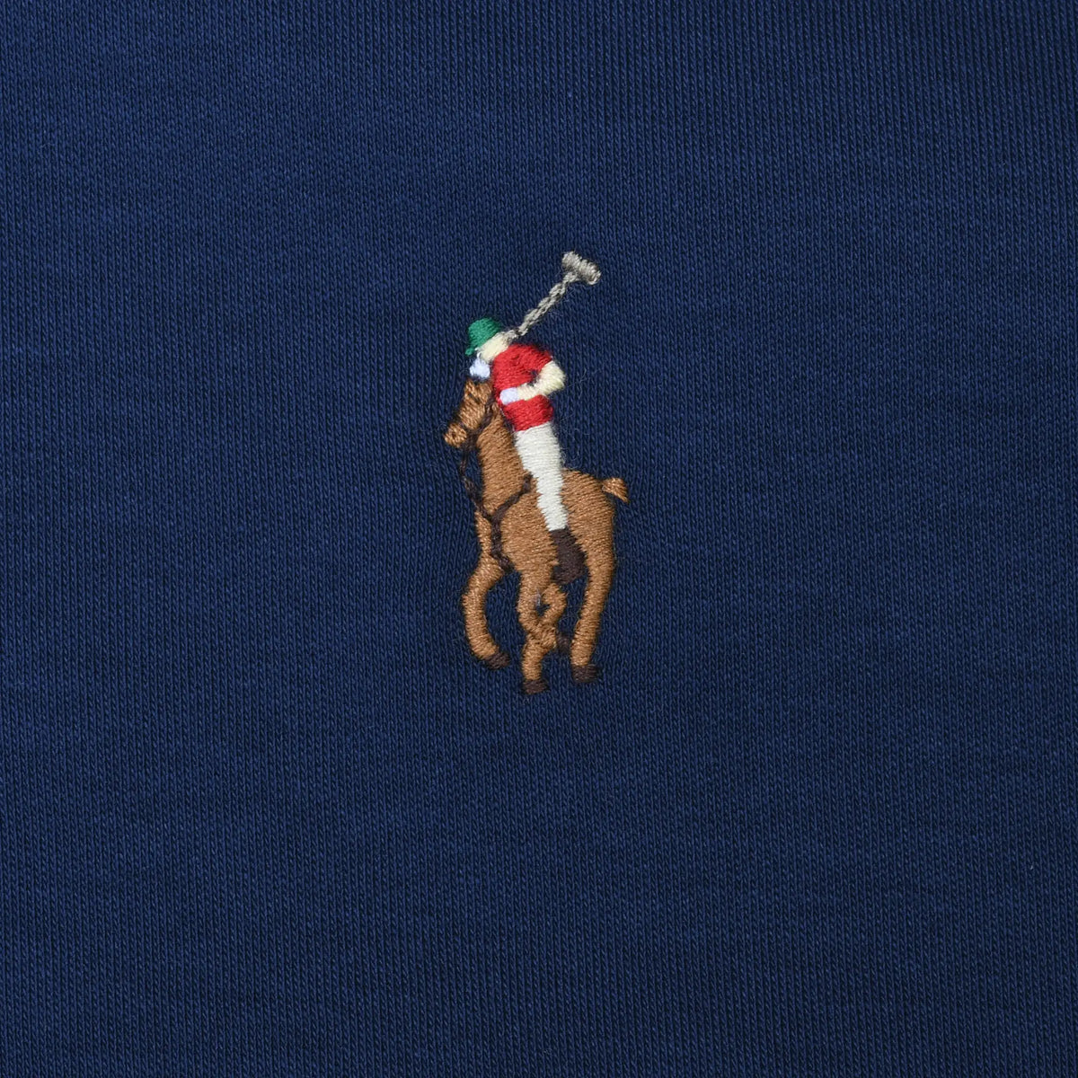 Close-up of multicolor Polo Ralph Lauren pony embroidery on navy fabric