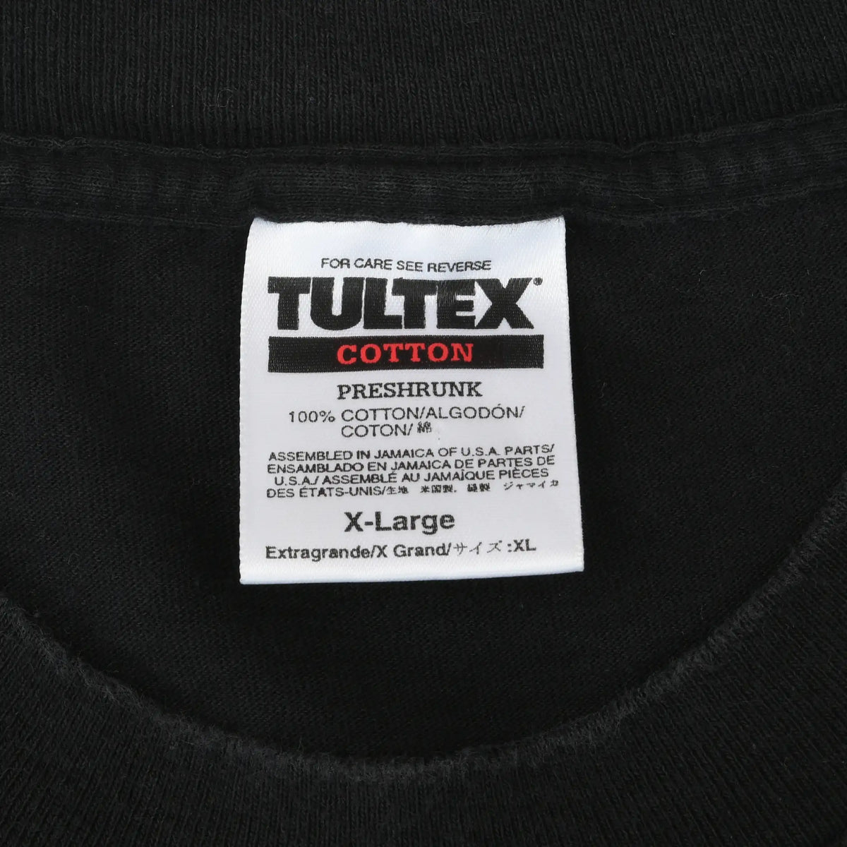 Close-up of Tultex neck label marked cotton, preshrunk, and size X-Large