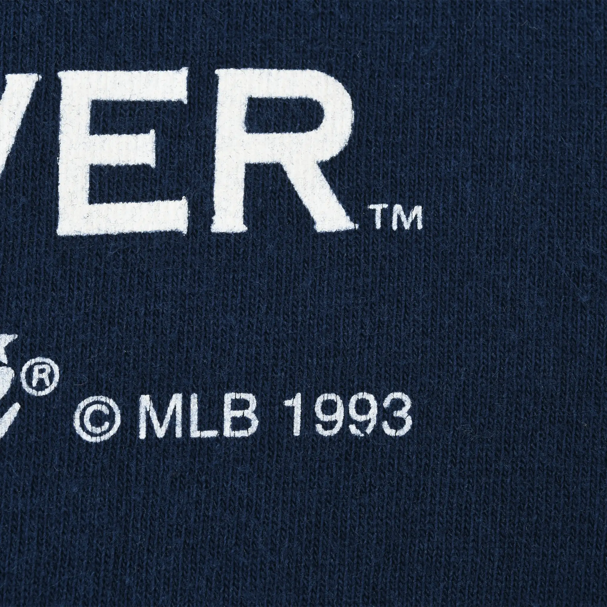 Close-up of MLB 1993 copyright text printed on navy fabric