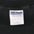 Close-up of Gildan Activewear Heavy Weight Cotton neck label on black T-shirt