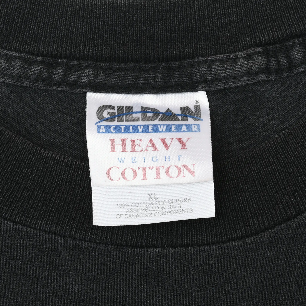Close-up of Gildan Activewear Heavy Weight Cotton neck label on black T-shirt