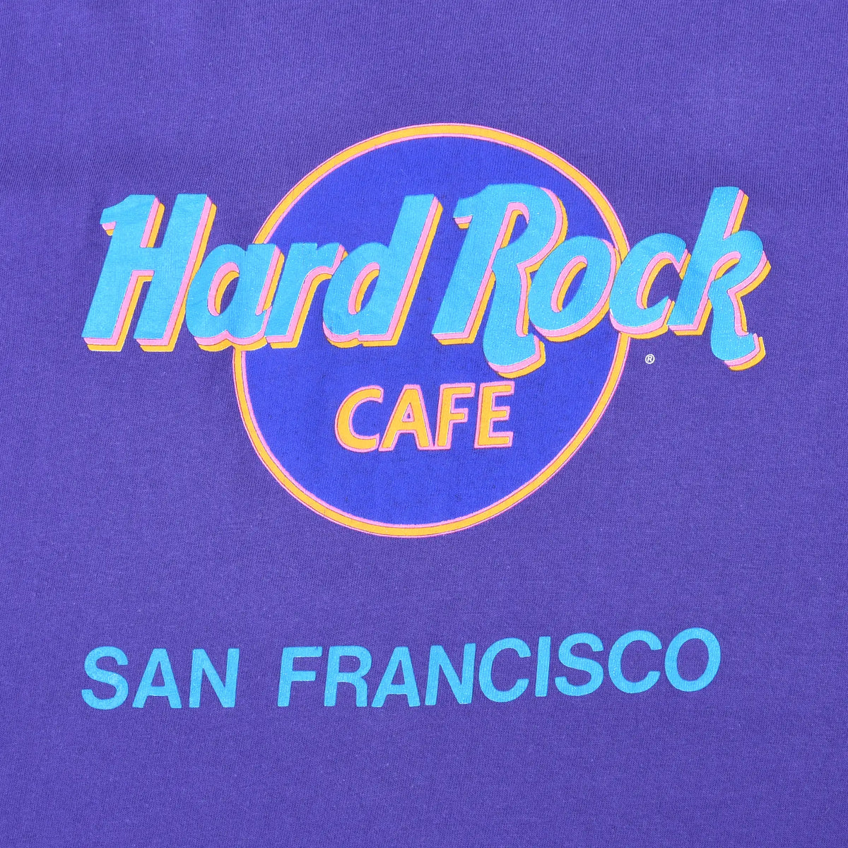 Close-up of colorful Hard Rock Cafe San Francisco front print on purple fabric