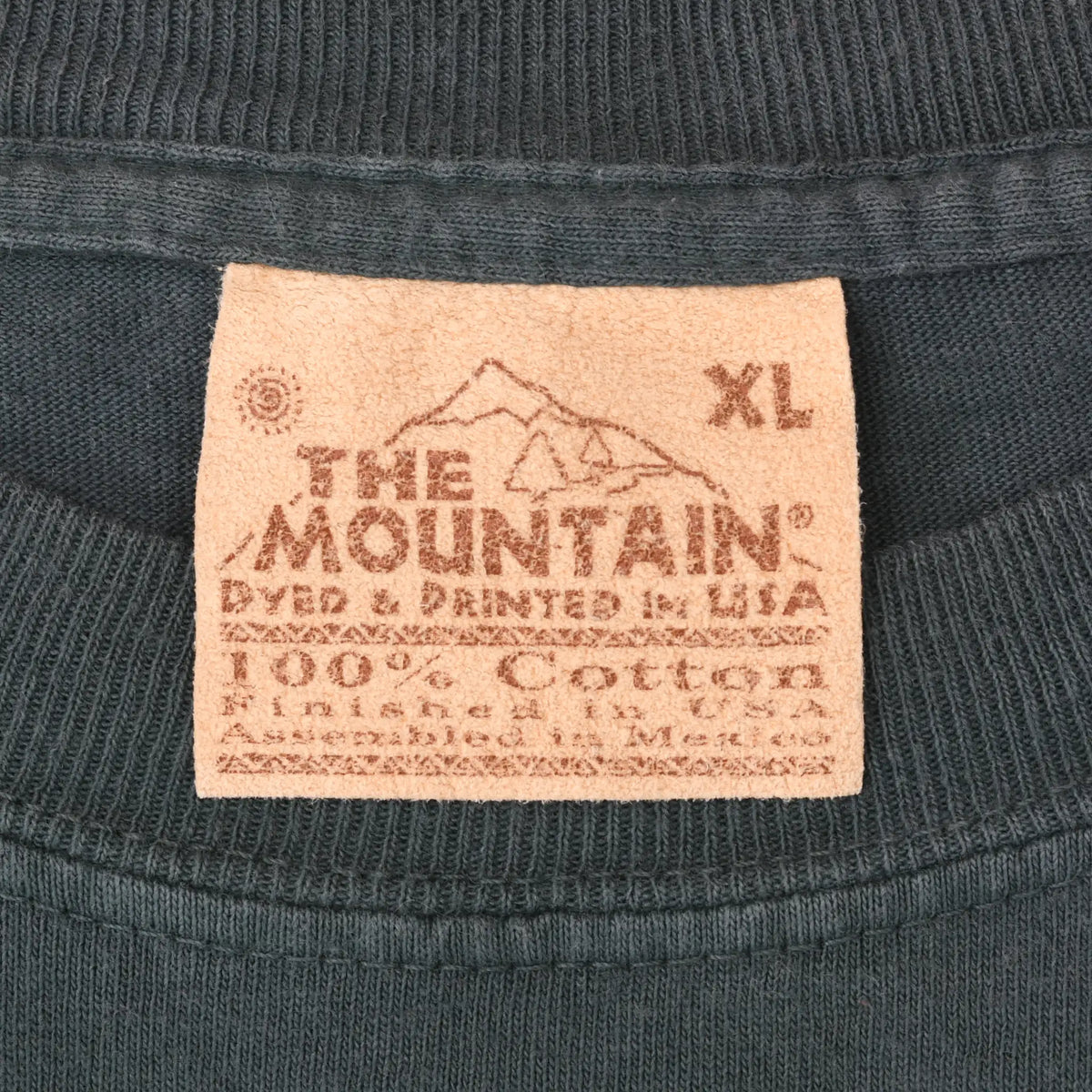 The Mountain neck label marked XL on blue-gray T-shirt