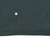 Close-up of lower T-shirt hem with marker indicating a small reddish spot