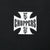 Close-up of white West Coast Choppers cross graphic on black fabric
