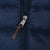 Close-up of Polo-engraved zipper pull with brown tab on navy puffer jacket