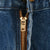 Close-up of brass YKK zipper fly on blue Carhartt jeans