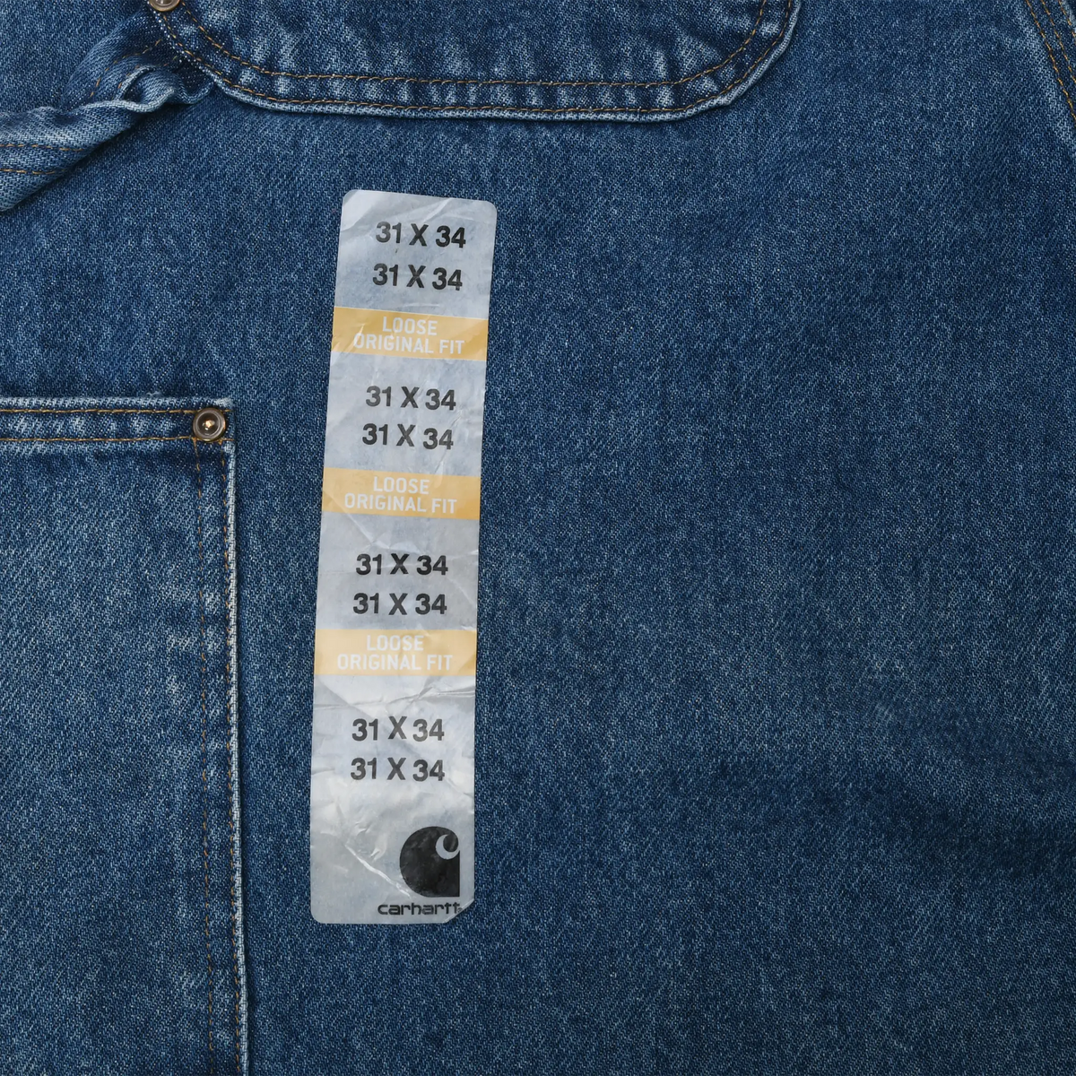Carhartt 31 x 34 loose original fit size sticker on blue denim