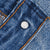 Close-up of metal button stamped 515 on Levi's blue jeans