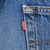 Close-up of red Levi's tab beside a back pocket seam on blue jeans