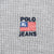 Close-up of Polo Jeans flag logo embroidery on grey waffle fabric