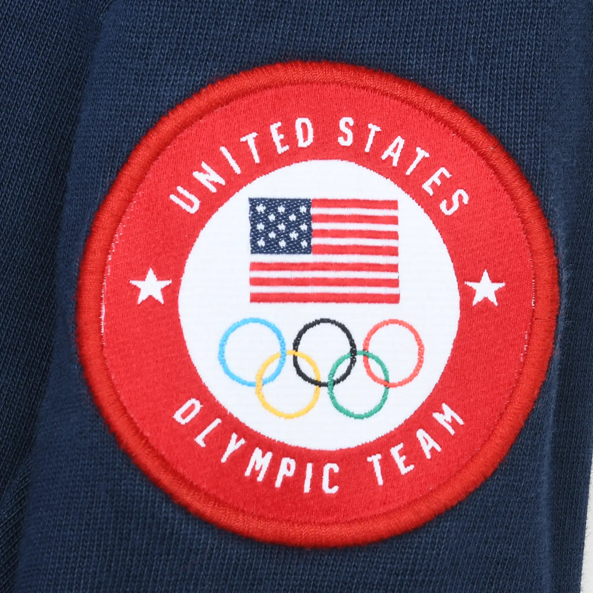 Close-up of red United States Olympic Team sleeve patch with flag and Olympic rings