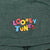 Close-up of multicolor Looney Tunes sleeve print on green striped fabric