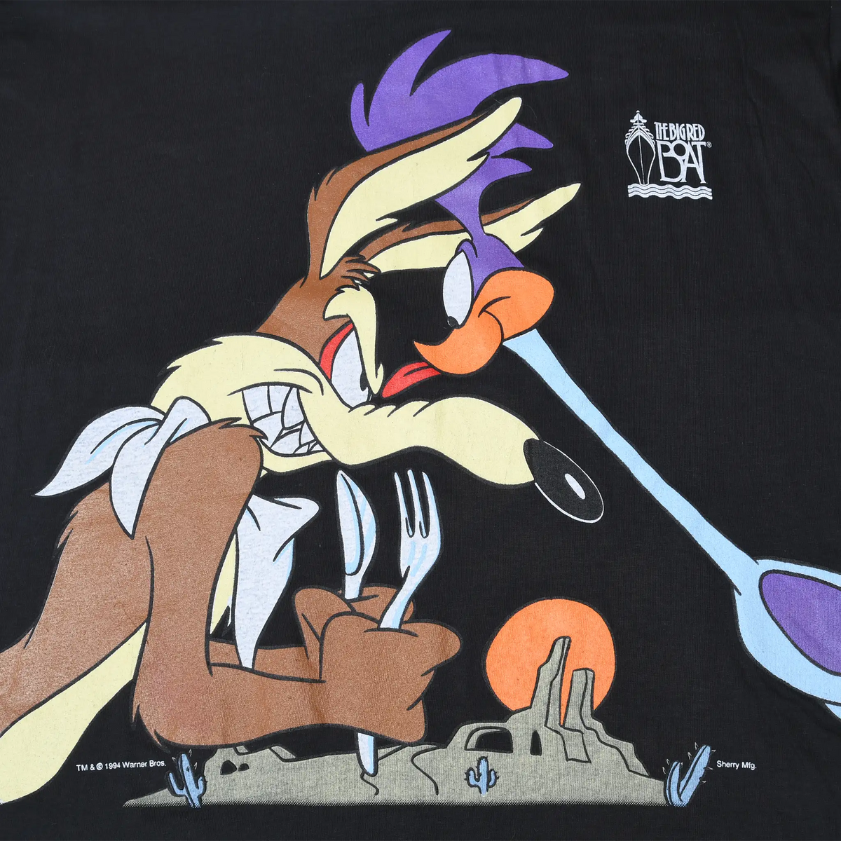 Close-up of Wile E. Coyote holding Road Runner in the front graphic on black T-shirt