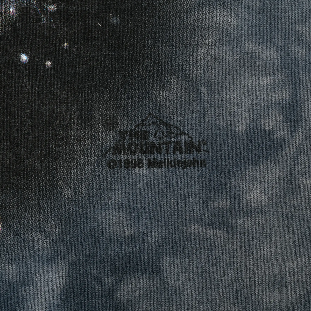 Close-up of The Mountain copyright mark printed beneath the wolf graphic