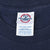 Close-up of Delta Pro Weight neck tag marked size L inside navy T-shirt