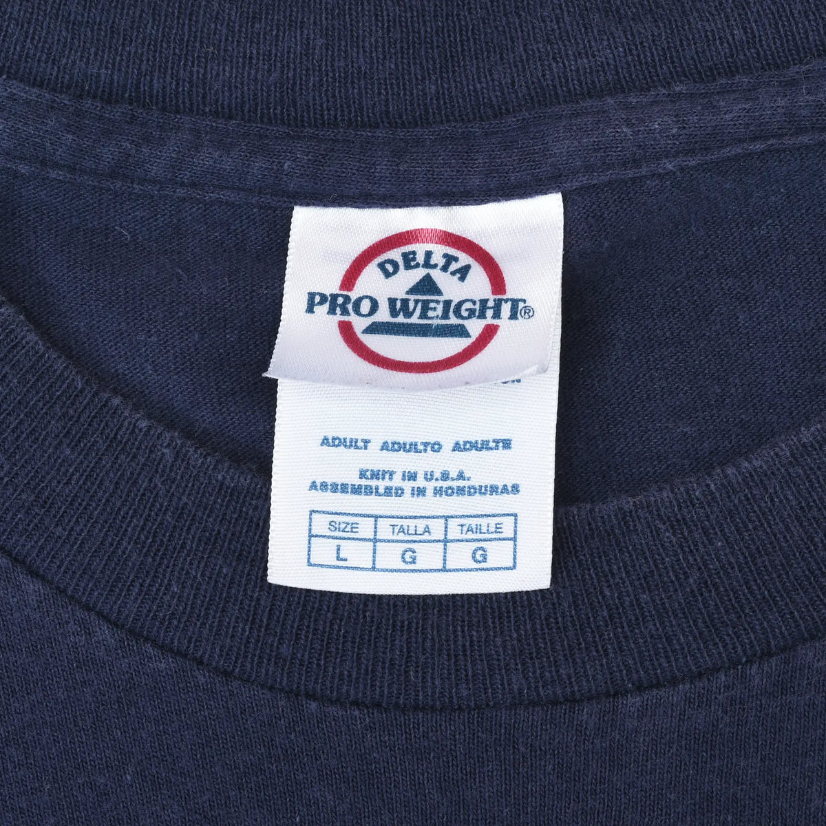Close-up of Delta Pro Weight neck tag marked size L inside navy T-shirt