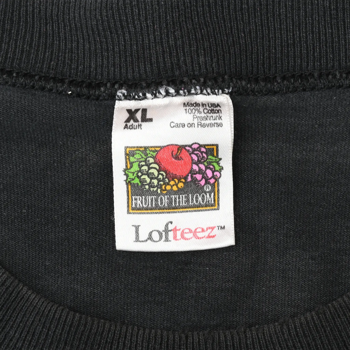Close-up of Fruit of the Loom XL neck label marked Made in USA and 100% cotton