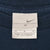Close-up of Nike neck tag marked size M and Made in Honduras of U.S.A. fabric