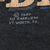 Close-up of 1987 3D Emblem Fort Worth, Texas copyright imprint on black fabric