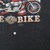Close-up of lower front Harley-Davidson graphic and small hole in charcoal fabric