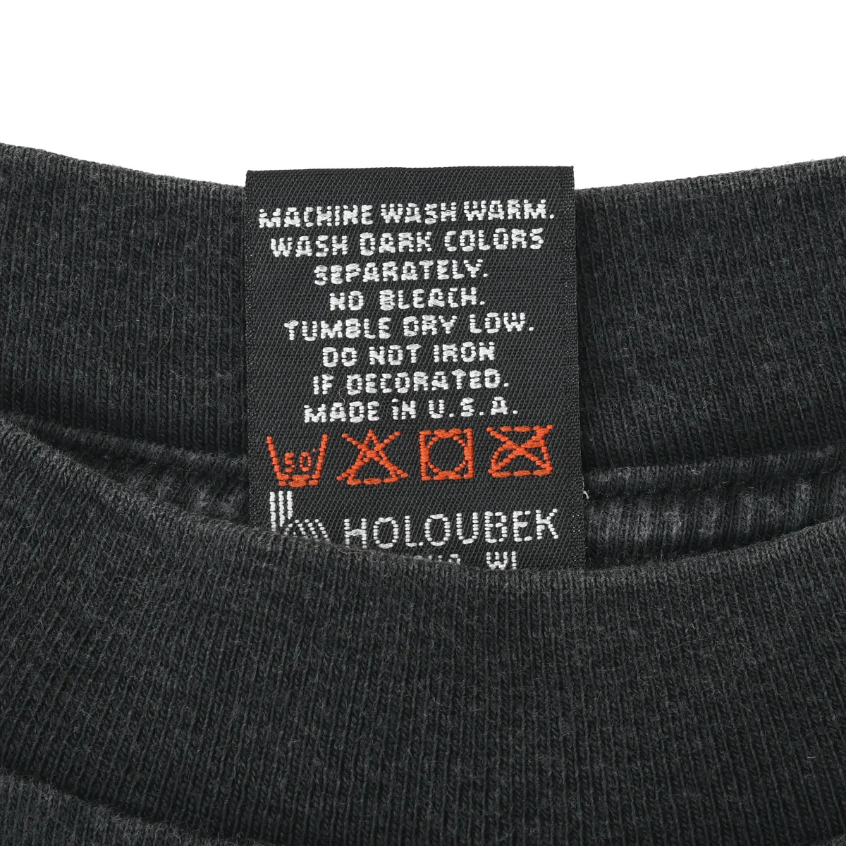Care label with washing instructions, Made in USA text, and Holoubek branding