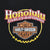 Close-up of Honolulu Hawaii Harley-Davidson chest logo print on black fabric
