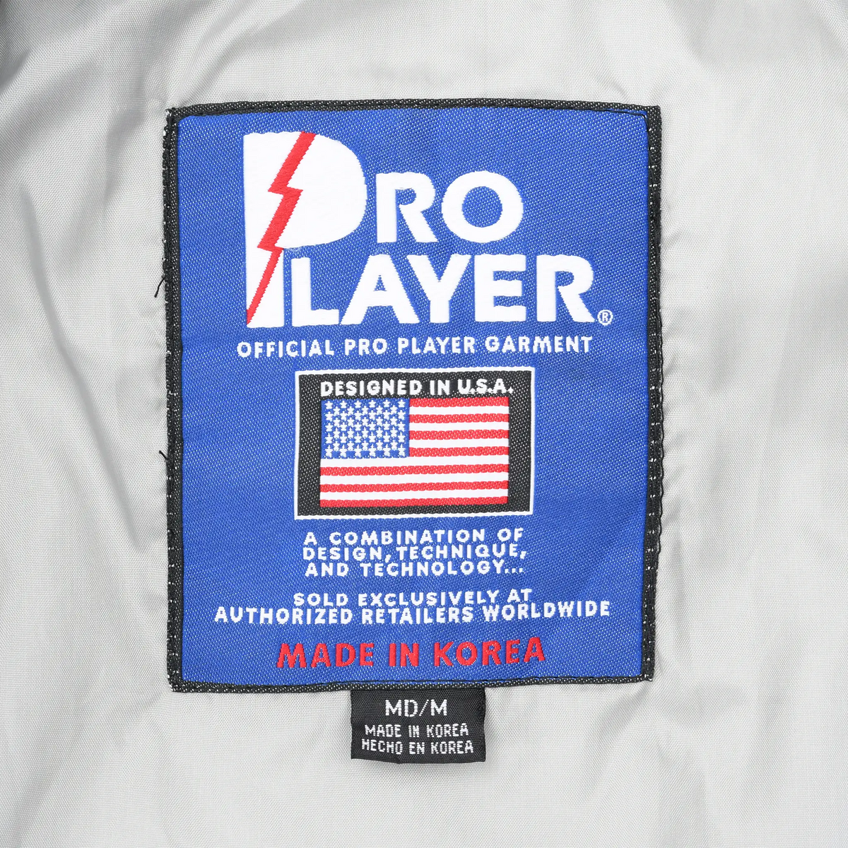 Pro Player interior garment label with American flag graphic and M/M size tag