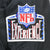 Close-up of embroidered NFL Experience patch on black jacket sleeve